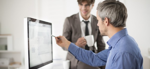 two men accessing Academy LMS on desktop